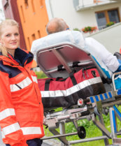 a patient on a stretcher with two paramedics