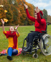 a disabled woman with her friend in the park
