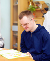 young adult man engages himself to study in the rehabilation center