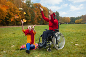 a disabled woman with her friend in the park